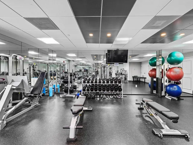 a room with gym equipment and lots of gym equipment