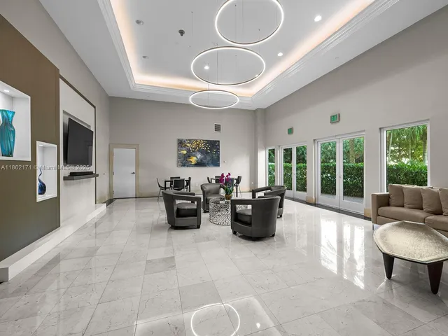 a living room with furniture a flat screen tv and a large window