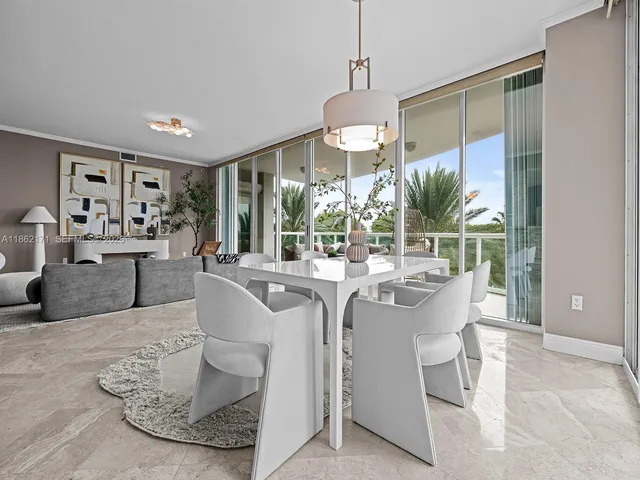 a living room with furniture a chandelier and a large window