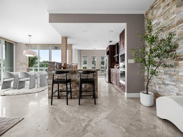 a view of a livingroom with furniture and a kitchen