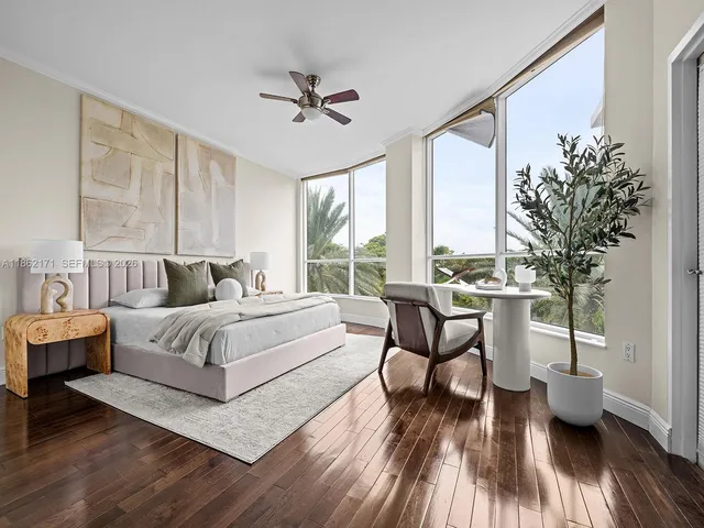 a spacious bedroom with a bed and wooden floor