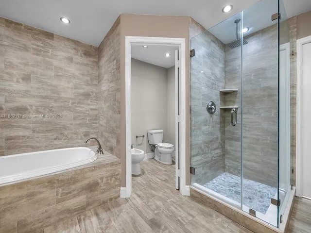 a spacious bathroom with a bathtub and a shower