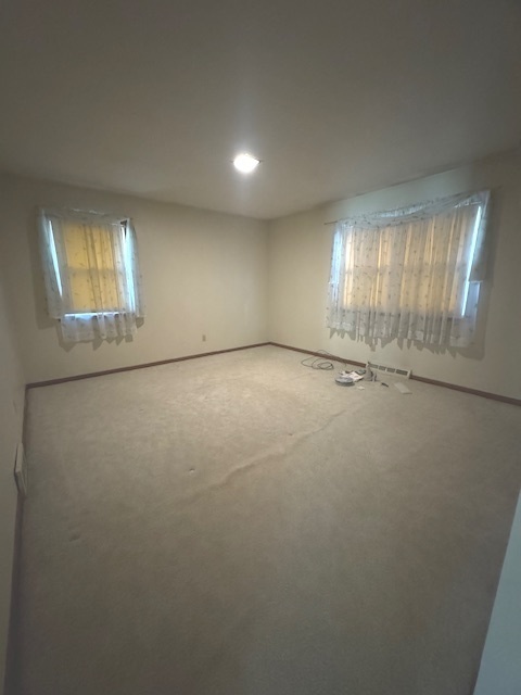 1518 Sharon Road Streator, IL 61364 - Photo 15 of 37 an empty room with windows and chandelier fan