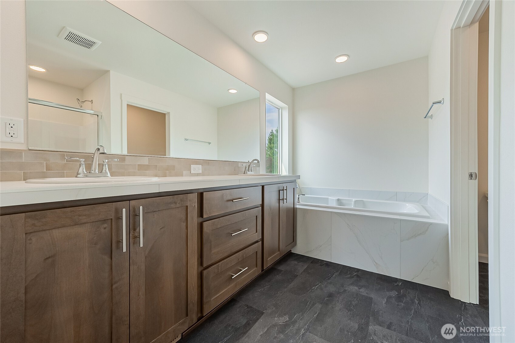960 RW Fletcher Street Winlock, WA 98596 - Photo 21 of 40 a bathroom with a granite countertop sink mirror and bathtub