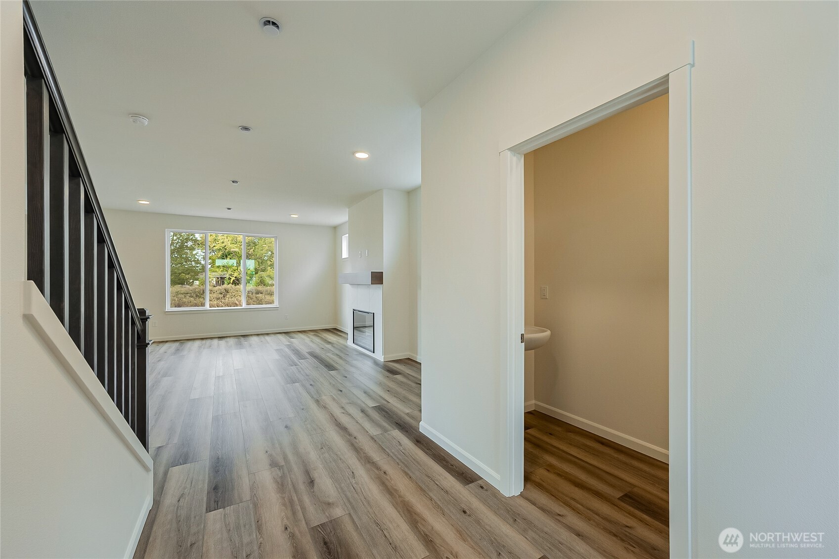960 RW Fletcher Street Winlock, WA 98596 - Photo 5 of 40 a view of an empty room with wooden floor and a window