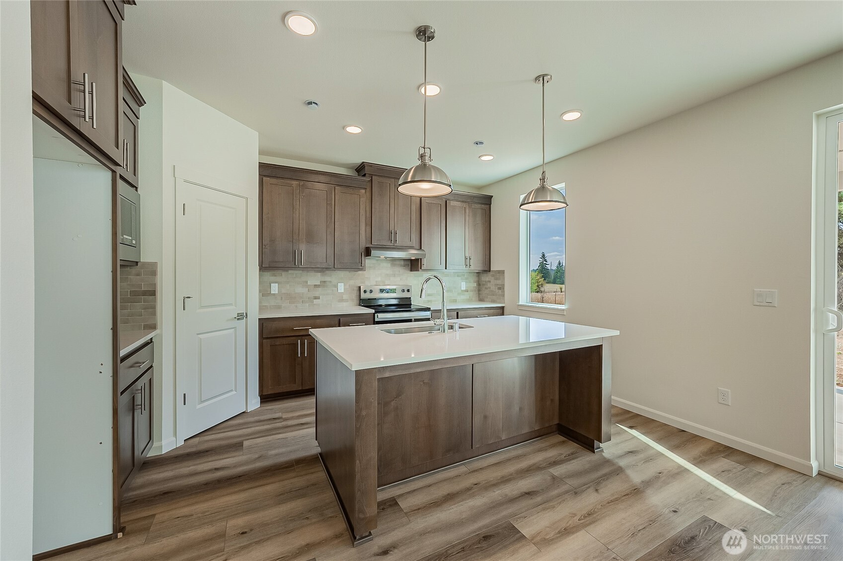 960 RW Fletcher Street Winlock, WA 98596 - Photo 7 of 40 a kitchen with kitchen island a sink stainless steel appliances and cabinets