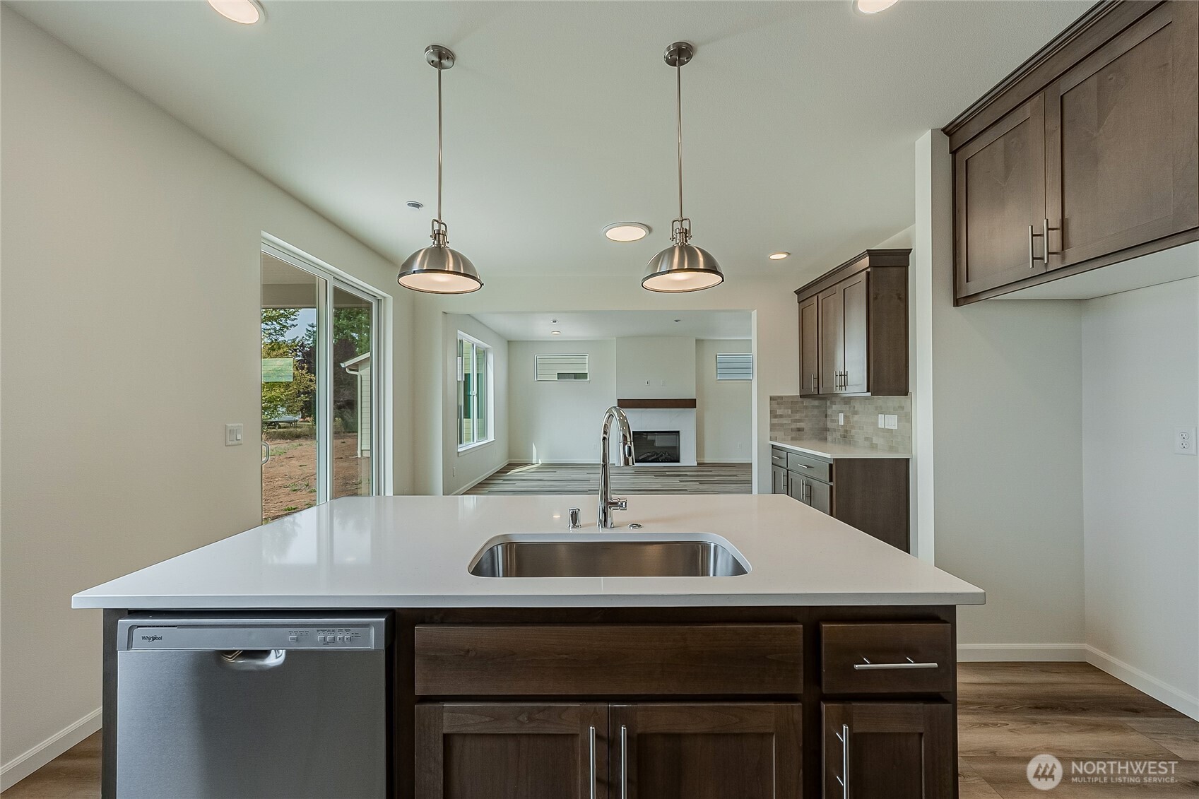 960 RW Fletcher Street Winlock, WA 98596 - Photo 8 of 40 a kitchen with a sink a center island and cabinets