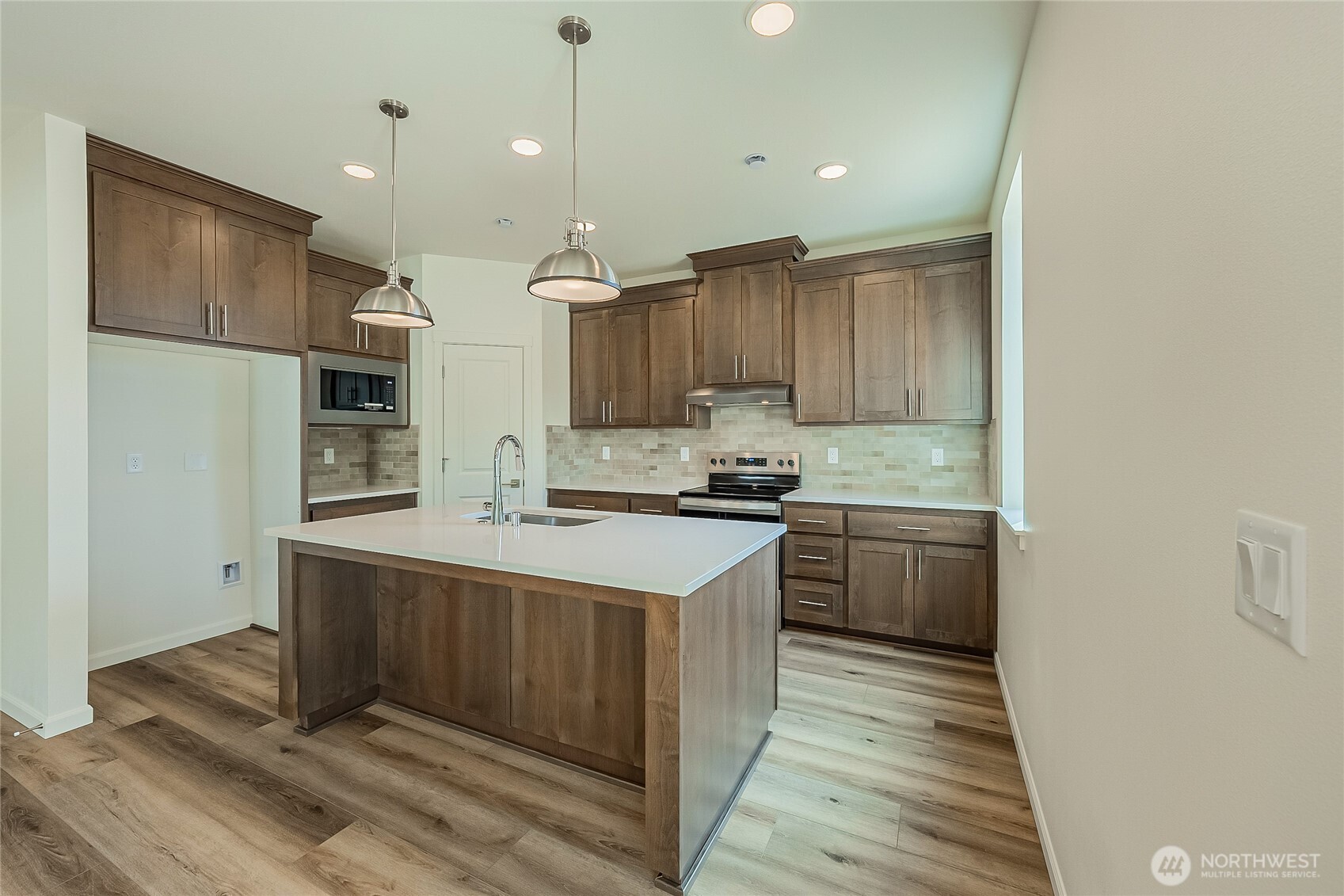 960 RW Fletcher Street Winlock, WA 98596 - Photo 9 of 40 a kitchen with kitchen island granite countertop a sink cabinets and stainless steel appliances