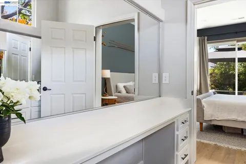 a bedroom with a bed and a large mirror