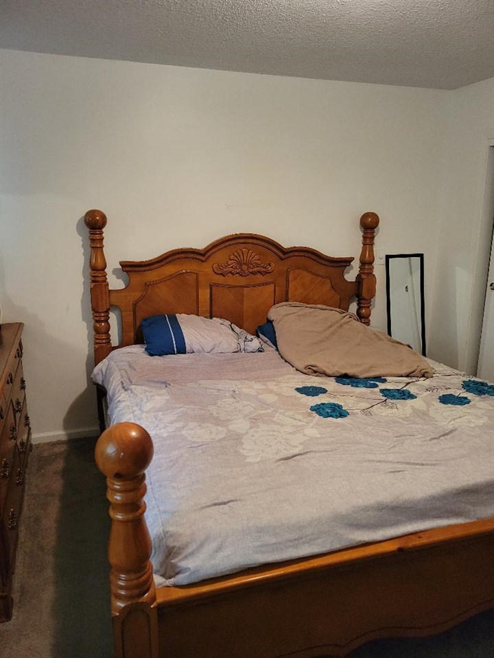4039 Hobson Road Memphis, TN 38128 - Photo 6 of 9 a bedroom with a bed and lamp on the table
