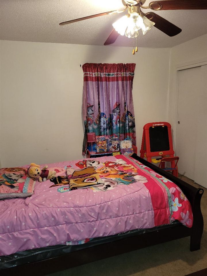 4039 Hobson Road Memphis, TN 38128 - Photo 8 of 9 a bedroom with a bed and a chandelier