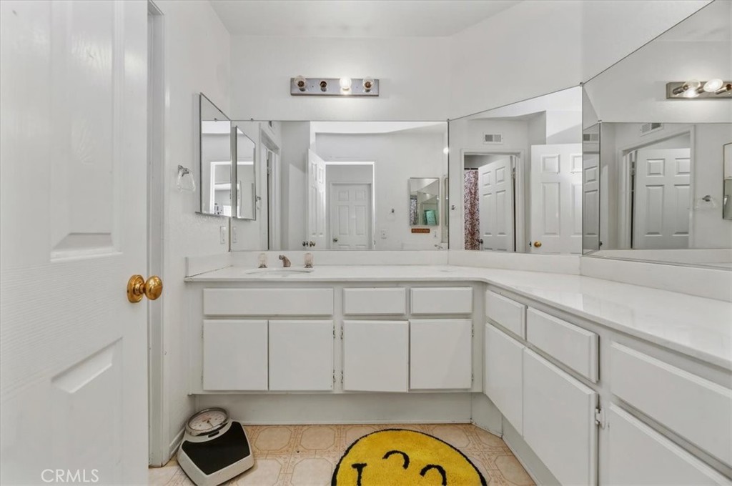 352 Leafwood Court Riverside, CA 92506 - Photo 35 of 42 a bathroom with a granite countertop sink mirror and vanity