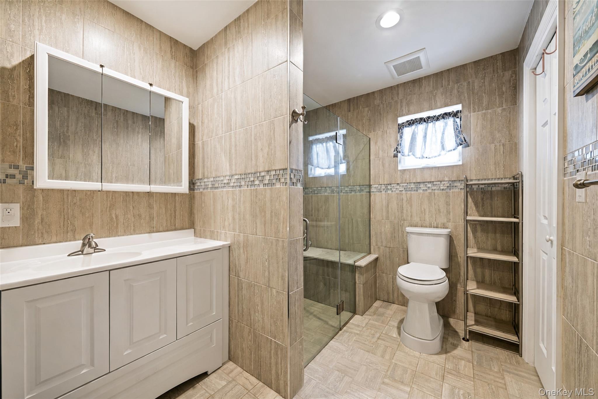 80 George Street Babylon, NY 11702 - Photo 27 of 41 a bathroom with a toilet sink a mirror and shower