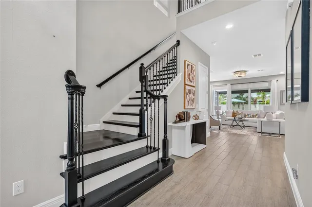 a kitchen with stainless steel appliances granite countertop a sink a stove and a wooden floors