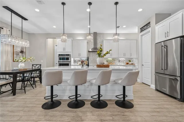 a dining room with furniture and wooden floor
