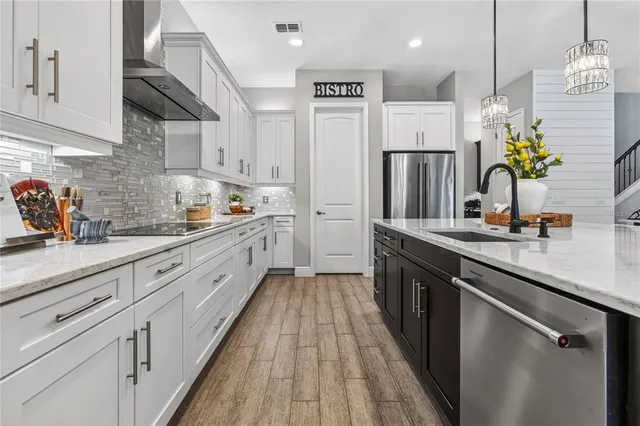 a spacious bedroom with a bed and a chandelier