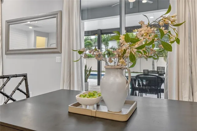 a view of an empty room with a window and a kitchen