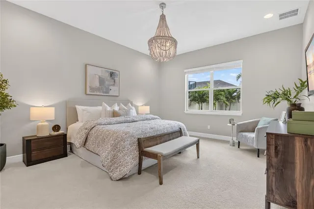 a lobby with furniture and potted plants