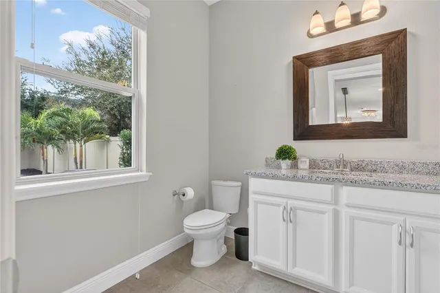 a bathroom with a granite countertop sink toilet a shower and a mirror