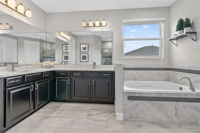 an aerial view of a house with garden space and a ocean view