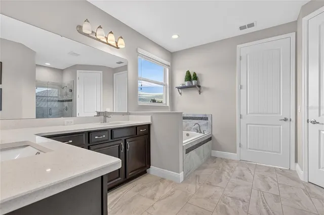 an aerial view of ocean and residential houses with outdoor space