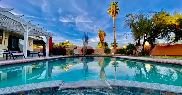 a view of a house with a backyard