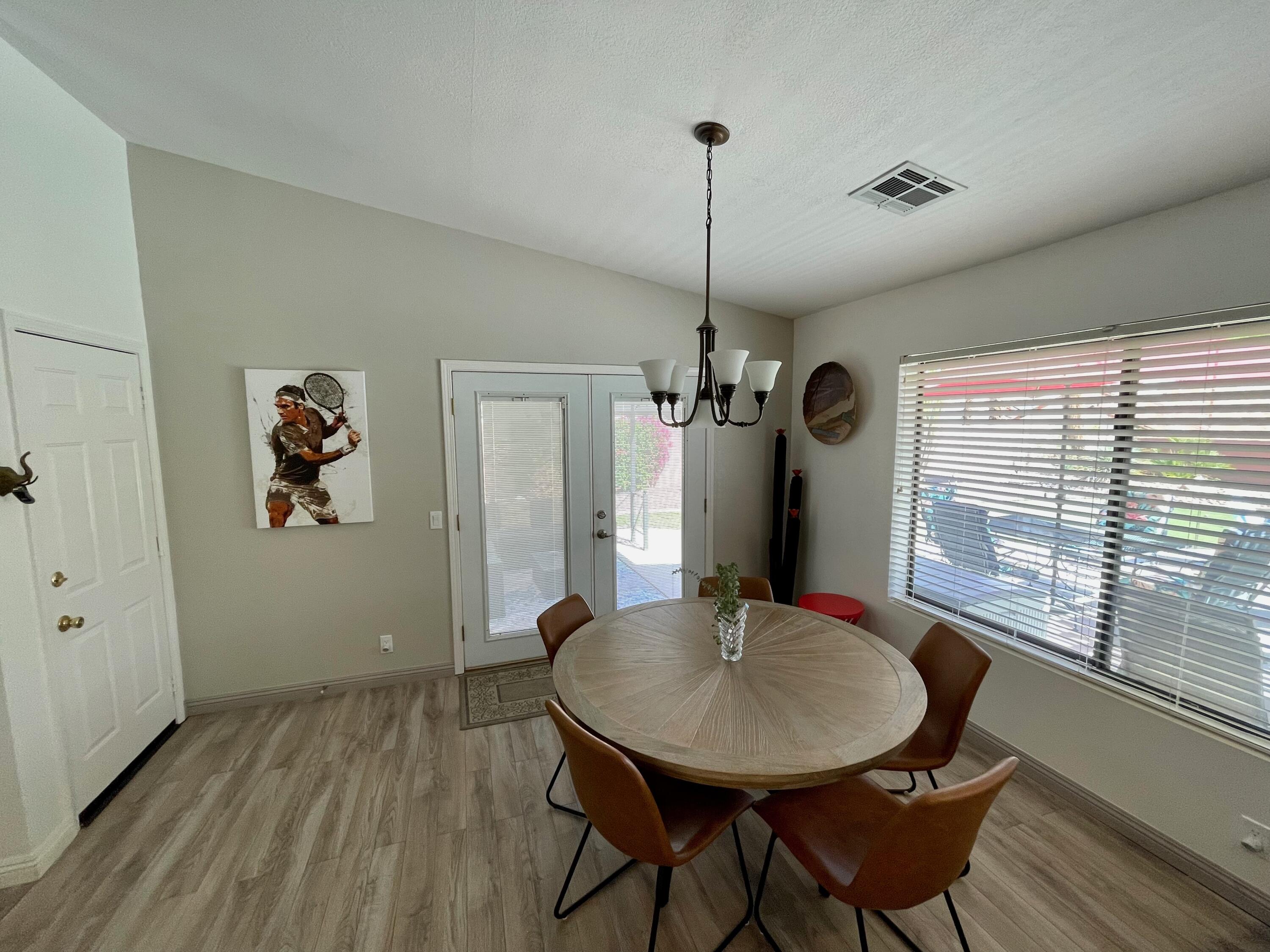 43622 Warner Trail Palm Desert, CA 92211 - Photo 17 of 51 a view of a dining room with furniture window and wooden floor