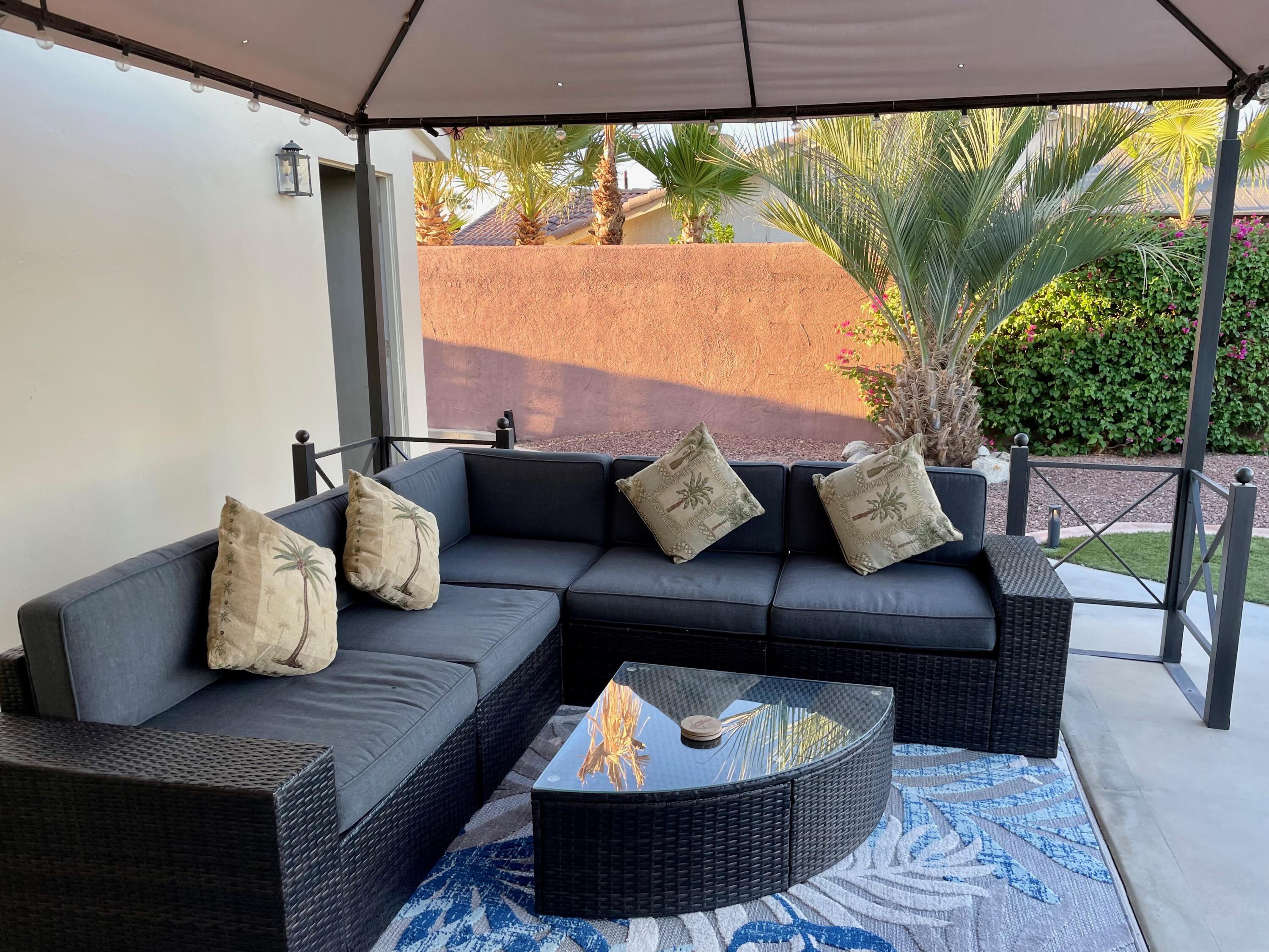 43622 Warner Trail Palm Desert, CA 92211 - Photo 36 of 56 a living room with furniture and a floor to ceiling window