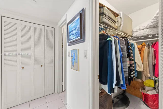 a view of walk in closet with clothes