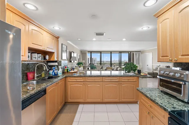a kitchen with stainless steel appliances granite countertop a sink and cabinets