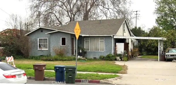 a front view of house with yard and outdoor seating