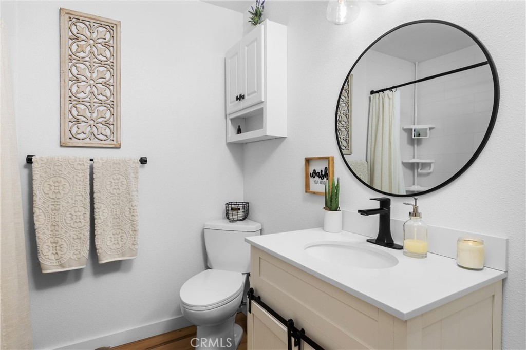 4913 Sparrow Hawk Lane Paso Robles, CA 93446 - Photo 17 of 33 a bathroom with a toilet a sink and a mirror