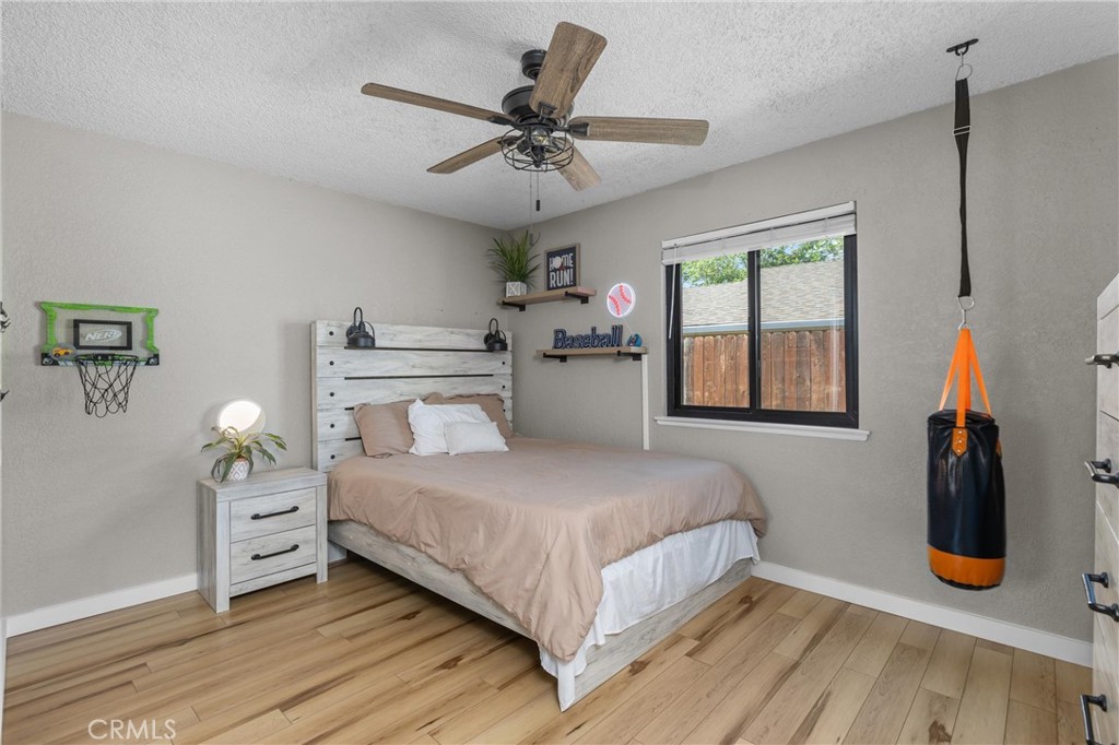 4913 Sparrow Hawk Lane Paso Robles, CA 93446 - Photo 18 of 33 a bedroom with a large bed and a chandelier