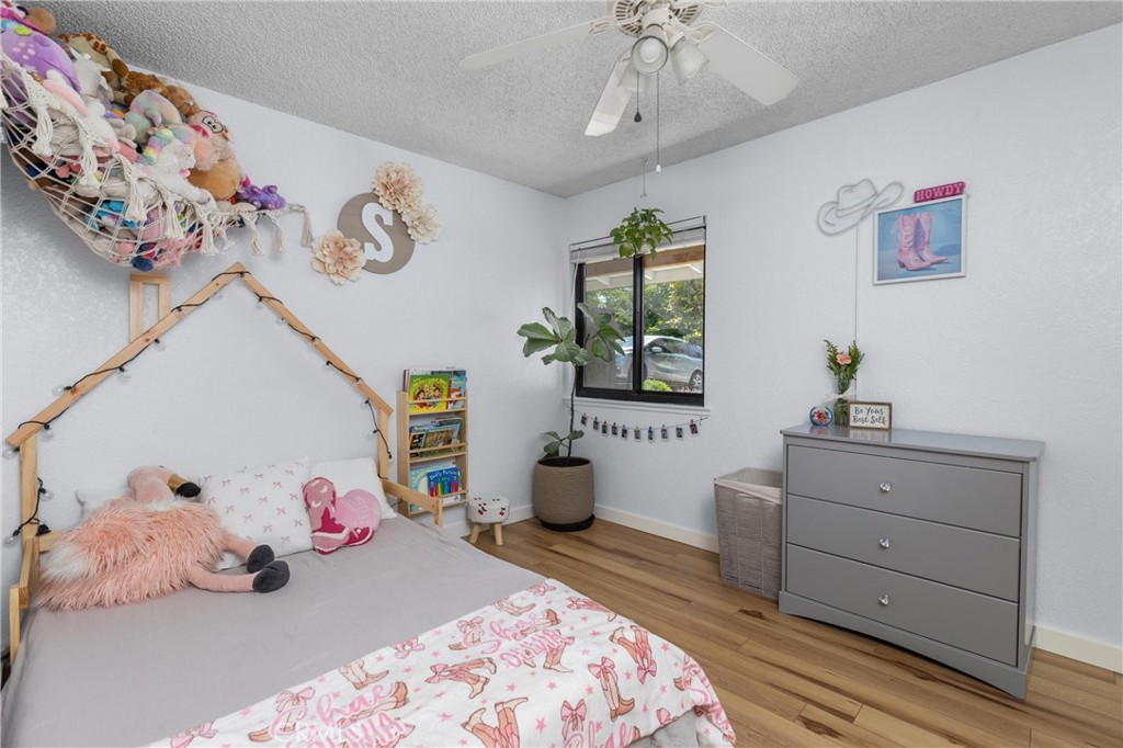 4913 Sparrow Hawk Lane Paso Robles, CA 93446 - Photo 19 of 33 a bedroom with a bed and a chandelier