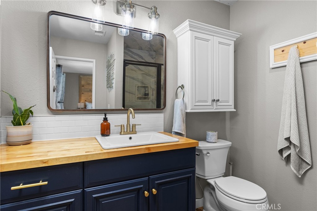 4913 Sparrow Hawk Lane Paso Robles, CA 93446 - Photo 20 of 33 a bathroom with a toilet sink and mirror