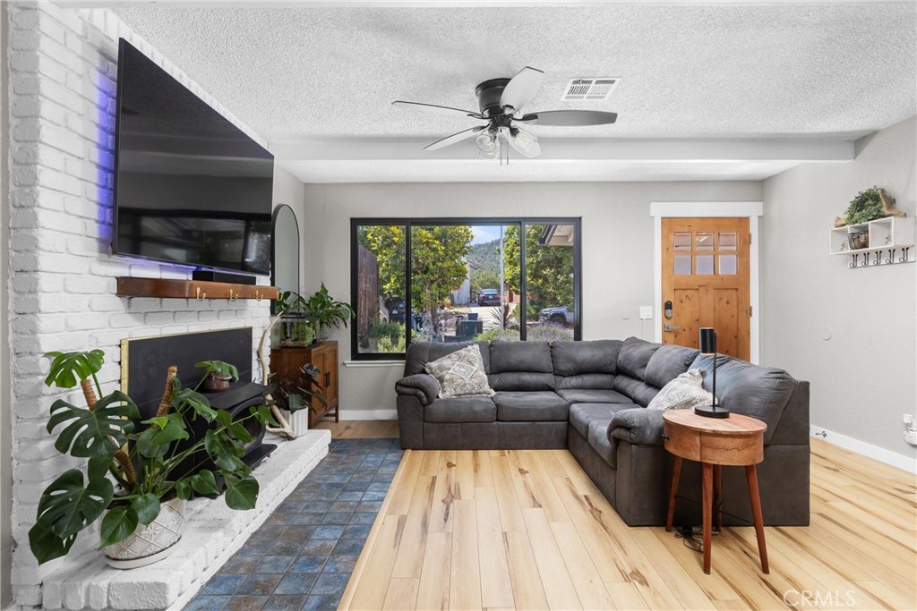 4913 Sparrow Hawk Lane Paso Robles, CA 93446 - Photo 8 of 33 a living room with furniture and a fireplace
