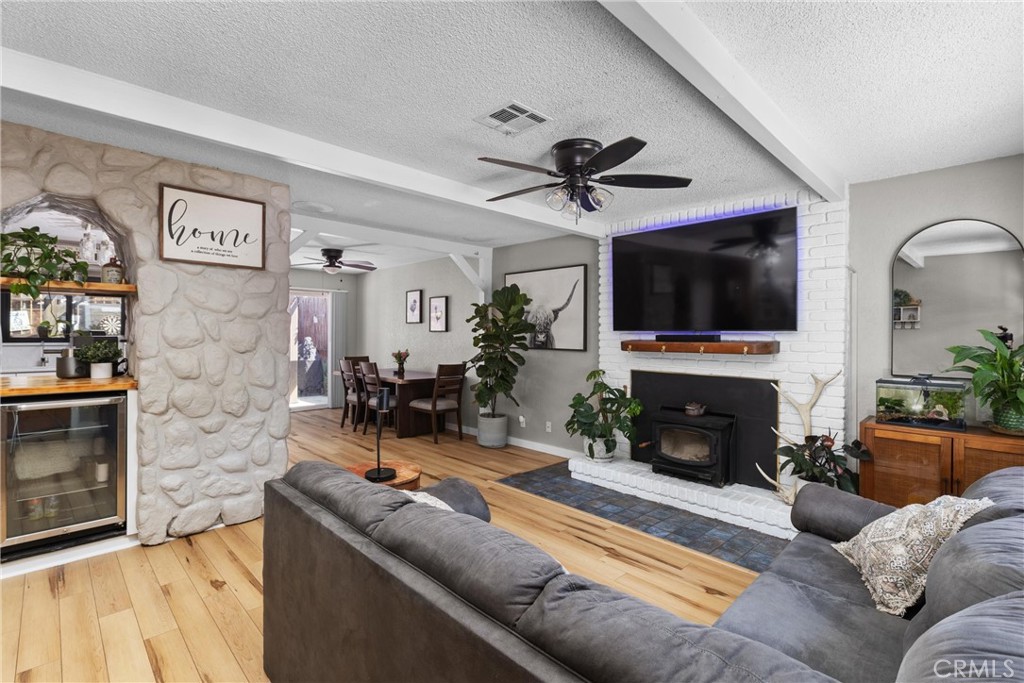 4913 Sparrow Hawk Lane Paso Robles, CA 93446 - Photo 9 of 33 a living room with furniture a flat screen tv and a fireplace