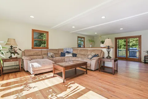 a living room with lots of furniture and wooden floor