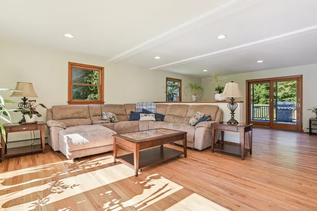 a living room with lots of furniture and wooden floor