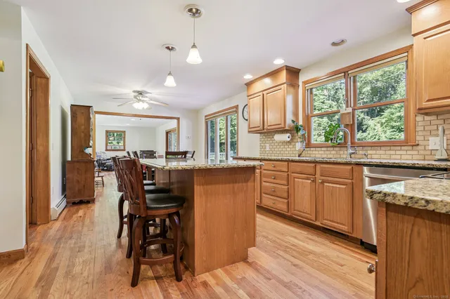 a kitchen with a table chairs refrigerator and cabinets
