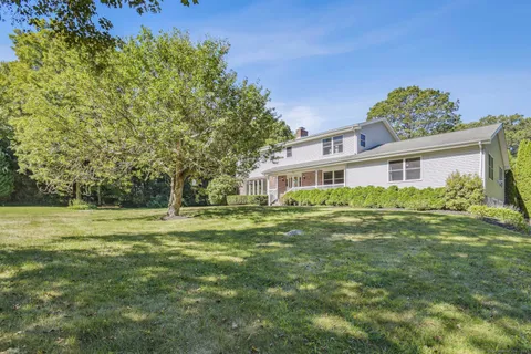 a front view of a house with a garden