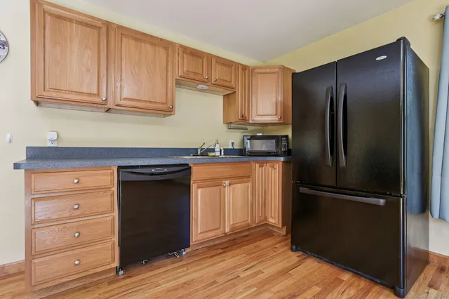 a kitchen with granite countertop stainless steel appliances and wooden cabinets