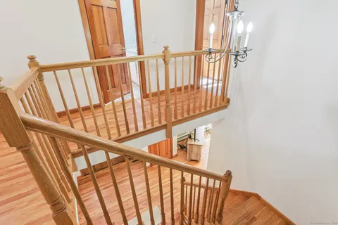a view of staircase with railing and a window