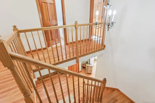 a view of staircase with railing and a window