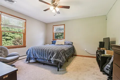 a spacious bedroom with a bed and couch