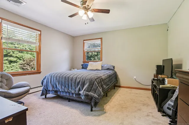 a spacious bedroom with a bed and couch
