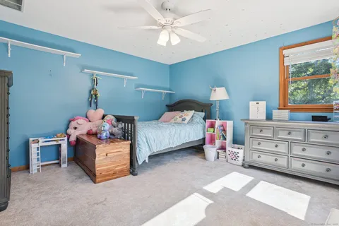 a bedroom with a bed and a dresser in it