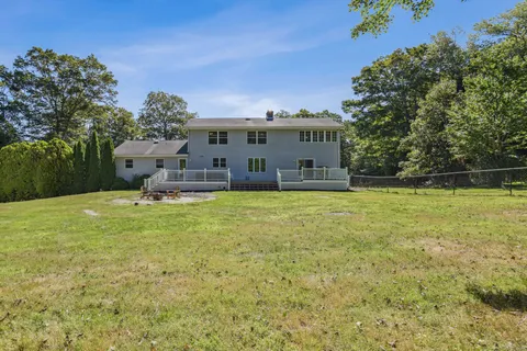 a view of a house with a yard and sitting area