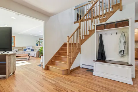 a view of entryway and hall with wooden floor