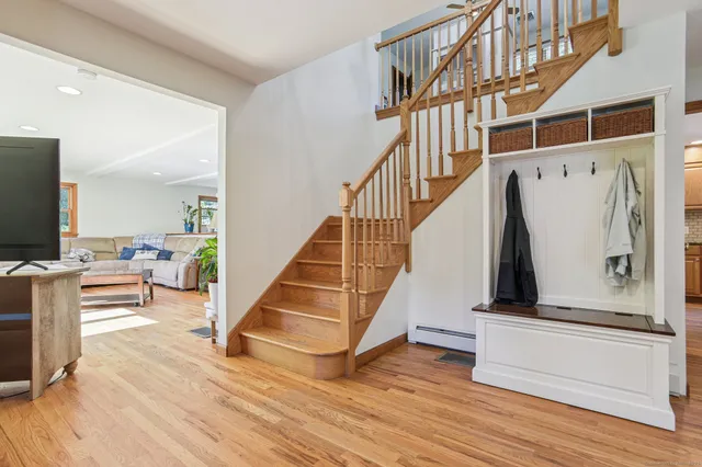 a view of entryway and hall with wooden floor